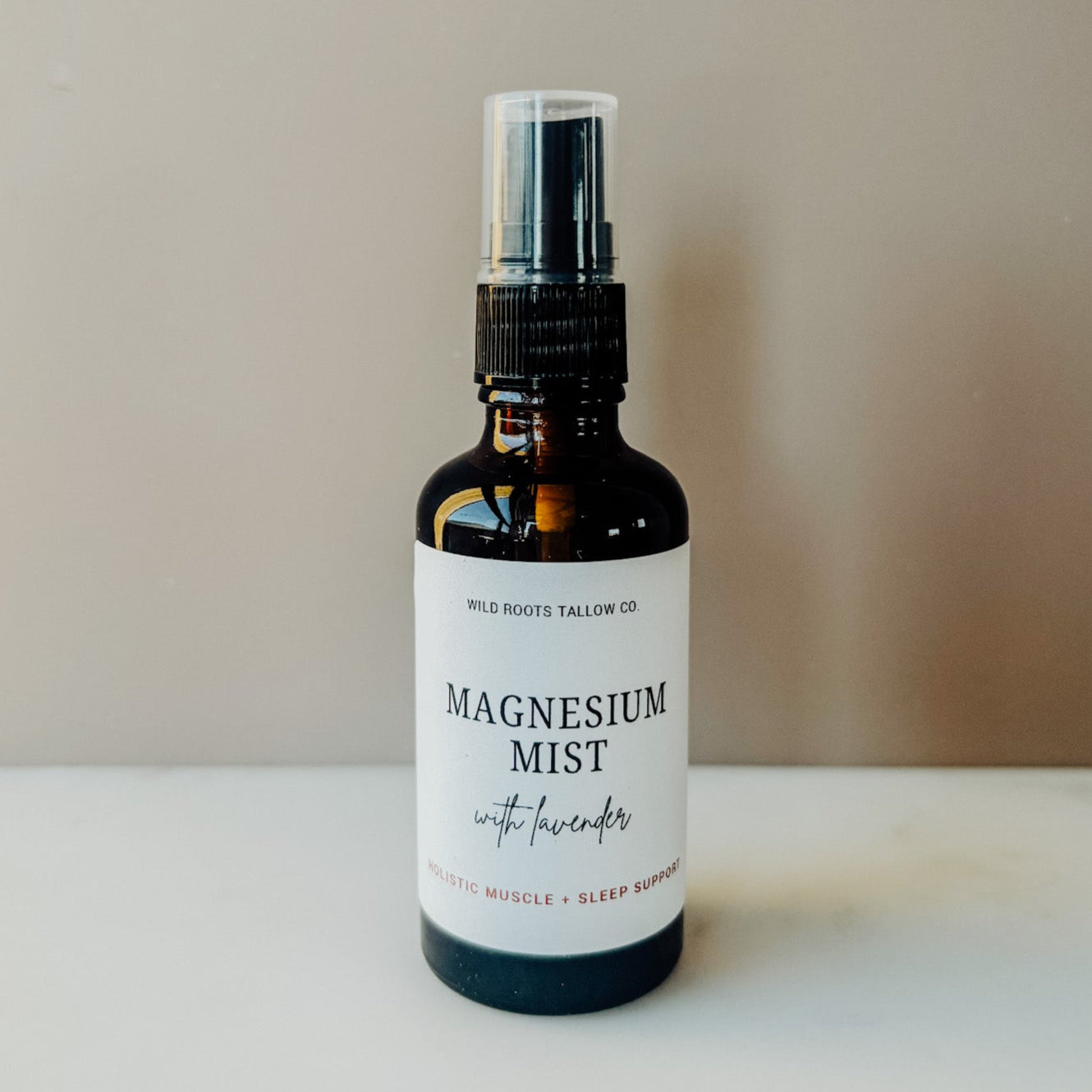 Bottle of magnesium mist with lavender on a neutral background