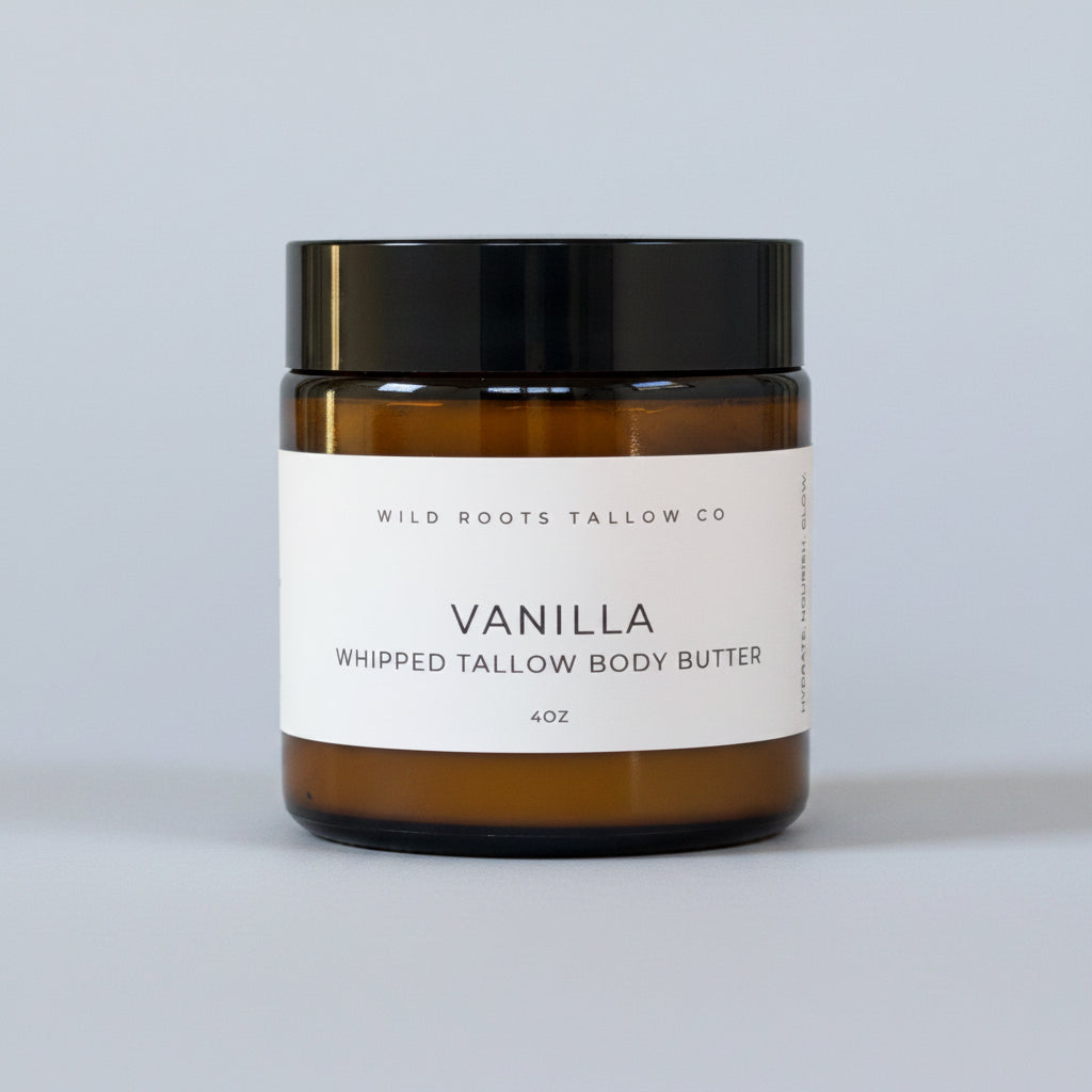 Jar of Vanilla Whipped Tallow Body Butter from Wild Roots Tallow Co on a wooden surface with a light gray background