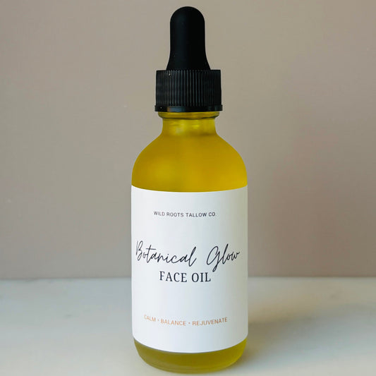 Bottle of Botanical Glow Face Oil with dropper on a neutral background