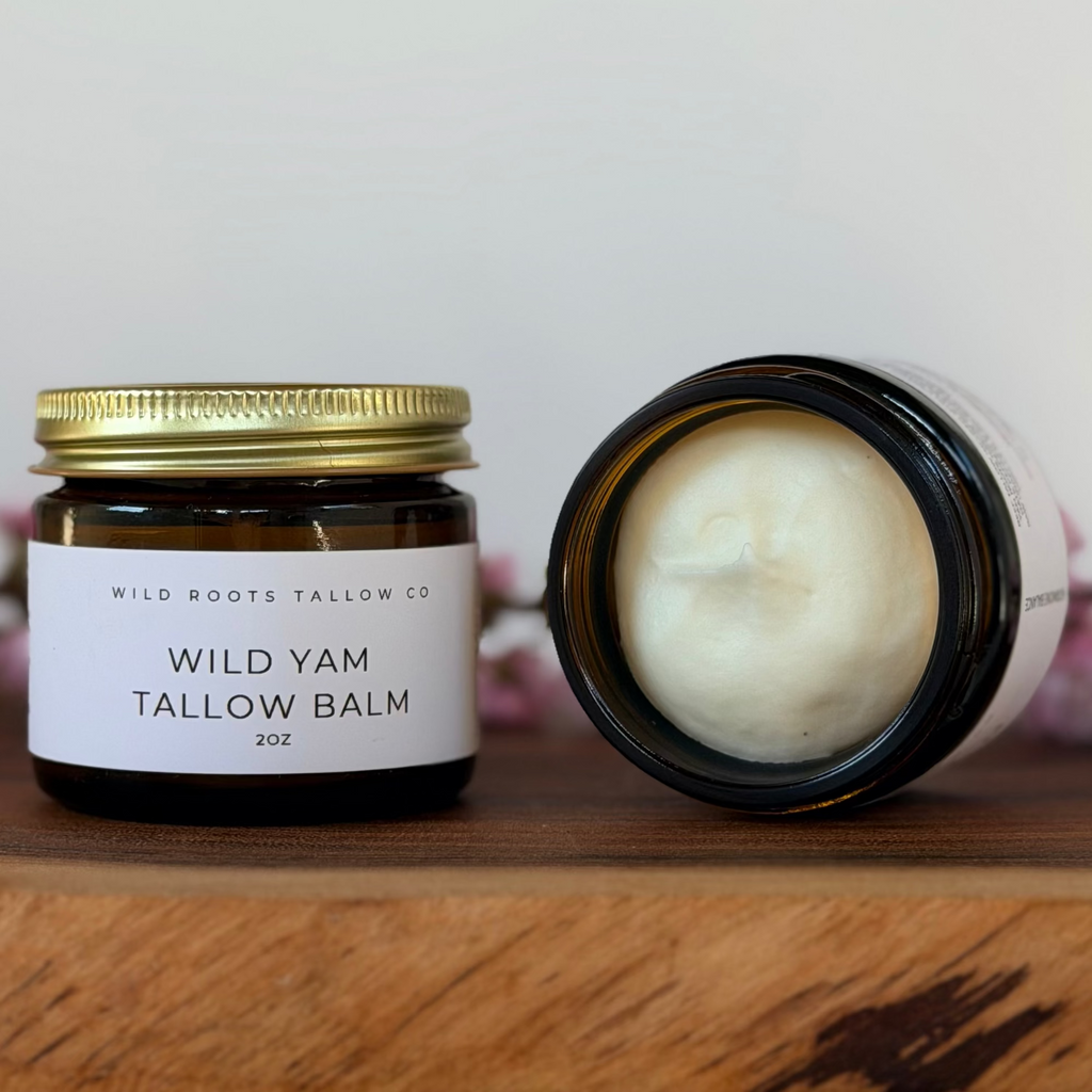 Two jars of Wild Yam Tallow Balm from Wild Roots Tallow Co on a wooden surface with a white background.