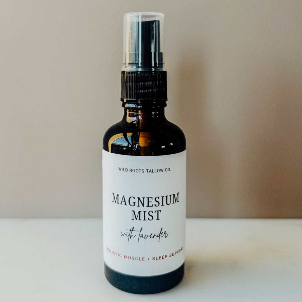 Bottle of magnesium mist with lavender on a neutral background